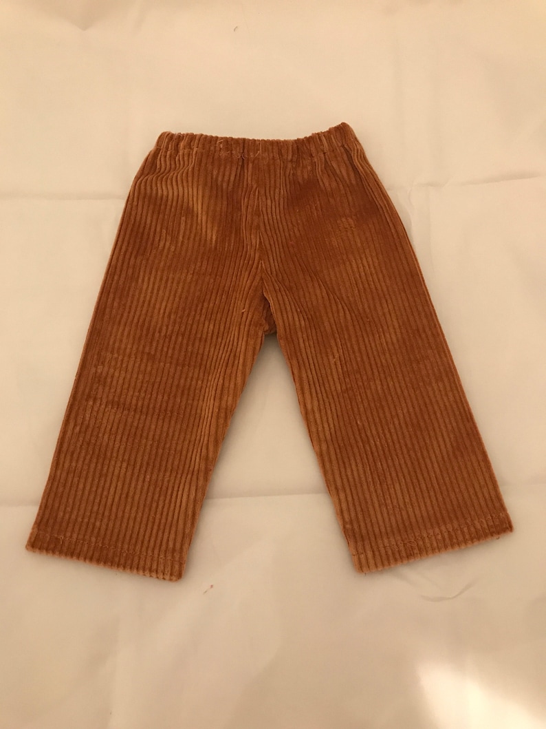 May include: A pair of brown corduroy trousers with a wide leg.