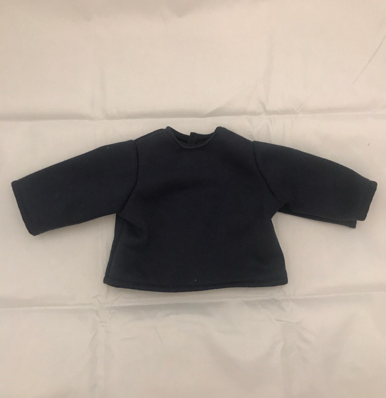 May include: A black long-sleeved shirt with a round neckline.