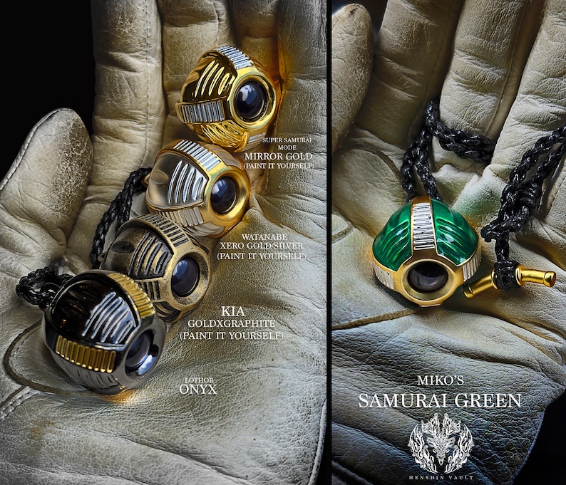 May include: Five different pendants, each with a unique design and colour. The pendants are made of metal and have a round shape. The pendants are on a black leather cord. The pendants are labelled with their names: Mirror Gold, Watanabe Xero Gold Silver, Kia GoldxGraphite, Lothor Onyx, and Miko's Samurai Green.