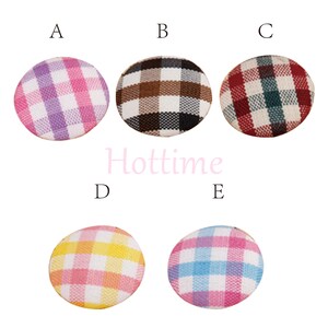 May include: Five round fabric buttons with a plaid pattern in various colors. The colors include purple and pink, brown and black, red and green, pink and yellow, and blue and pink. The word "Hottime" is in the center.