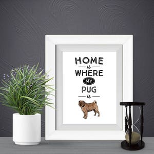 May include: White framed print with black text that reads "Home is where my pug is". A brown pug is illustrated below the text.