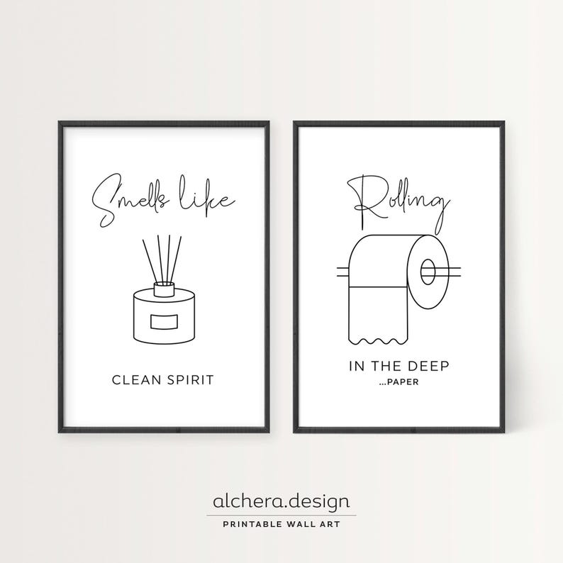 Two framed black and white line art prints: one of a diffuser with "Smells like clean spirit" and one of toilet paper with "Rolling in the deep...paper."