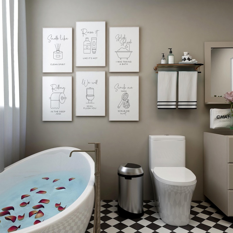 A bathroom with a white clawfoot tub, a toilet, and six framed black and white line art prints on the wall.