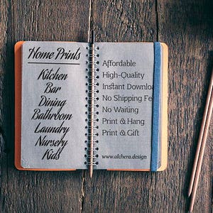 May include: An open notebook with the words "Home Prints" and a list of rooms, including "Kitchen," "Bar," and "Dining." The notebook is on a wooden surface, with pencils and a decorative strip nearby. The text also includes "Affordable" and "High-Quality."