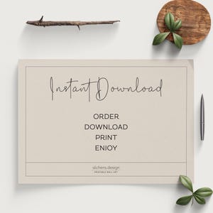 May include: A beige printable wall art design with the text "Instant Download" in cursive script. The text "Order, Download, Print, Enjoy" is listed below in a sans-serif font. The text "alchera.design Printable Wall Art" is at the bottom of the design.