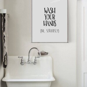 May include: White bathroom sink with a chrome faucet and a sign that reads "Wash Your Hands (No, Seriously)"