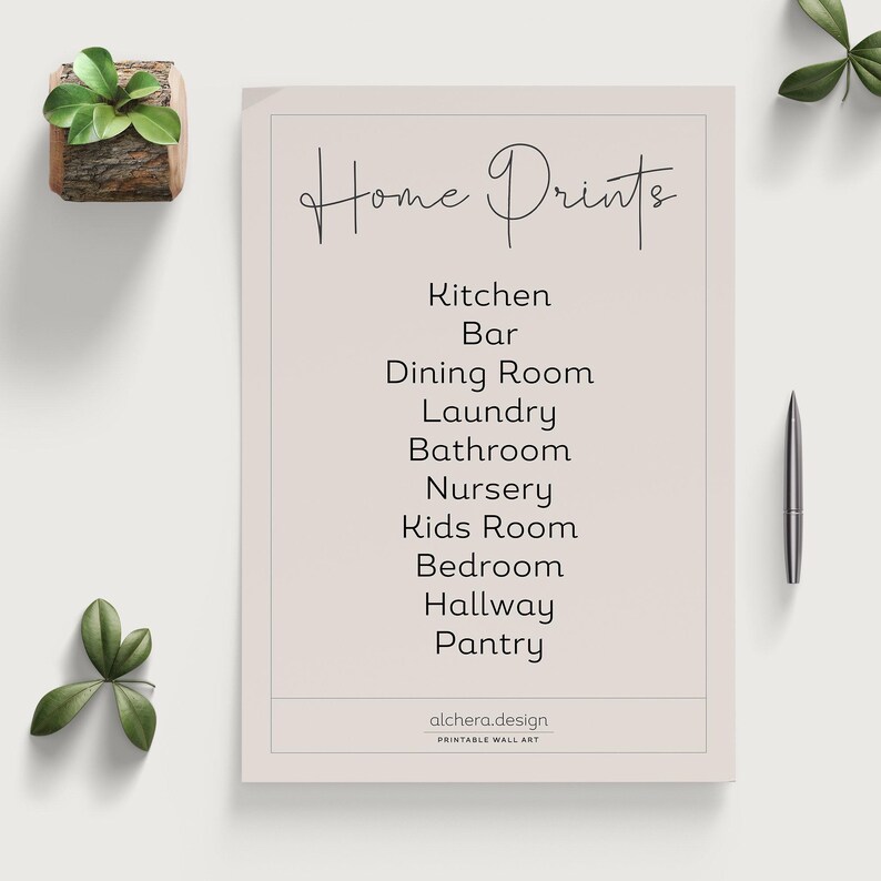 A light beige paper with "Home Prints" in script and a list of rooms like "Kitchen," "Laundry," and "Bedroom" in block letters, next to a pen and a small plant.