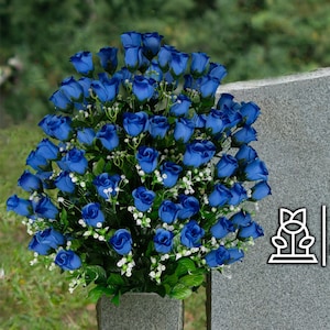 May include: A gray granite headstone with the text "FLOWERS FOR CEMETERIES" on it. A blue silk rose bouquet is placed in front of the headstone.