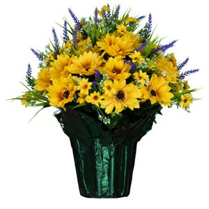 May include: A floral arrangement featuring bright yellow sunflowers and purple lavender sprigs with green foliage. The flowers are contained within a dark green, crinkled metallic foil wrap that forms a tapered, vase-like base for the bouquet.