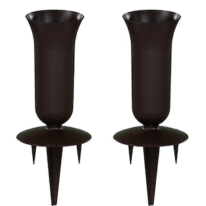 May include: Two dark brown flower vases with a textured surface. Each vase has a flared top, a round base, and three pointed stakes for ground placement. The vases are designed for outdoor use.