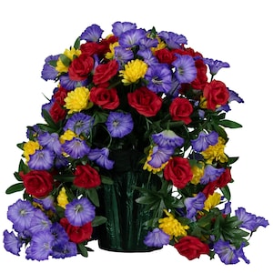 May include: A bouquet of artificial flowers in a green vase. The bouquet includes red roses, yellow mums, and purple flowers. The flowers are arranged in a cascading style.