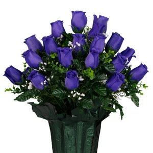 May include: A bouquet of purple silk roses arranged in a green vase. The roses are clustered together in a circular shape, with the stems extending out from the center.
