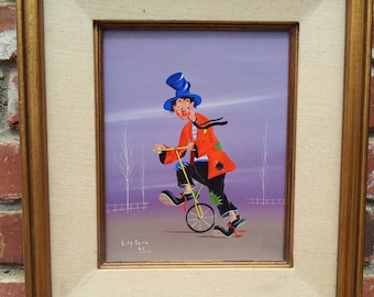 May include: A framed painting of a clown riding a unicycle. The clown is wearing a red and black costume, a blue hat, and white gloves. The background is a purple sky with white trees.