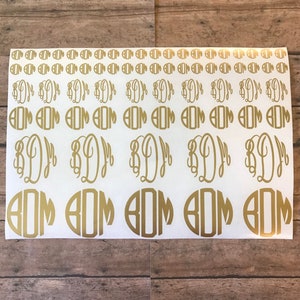 May include: A sheet of gold vinyl stickers with various sizes and styles of the monogram "BDJ".