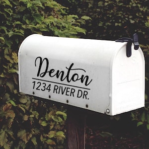 May include: White mailbox with black lettering that reads "Denton 1234 River Dr."
