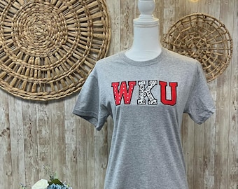 May include: Gray t-shirt with the letters WKU in red with a white and black leopard print design.