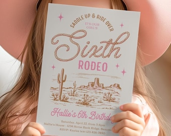 May include: A white rectangular birthday invitation card featuring brown rope-style text that reads Saddle Up & Ride Over It's Our Girl's Sixth Rodeo. The card includes a brown desert landscape illustration and pink text for Hallie's 6th Birthday.