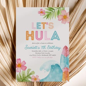 May include: A white invitation with the text "LET'S HULA" in colorful letters. The invitation includes details for a luau, with pink flowers, green leaves, a surfboard, and a wave design. The invitation is for Scarlett's 7th birthday.