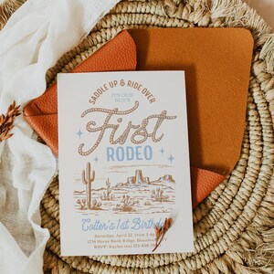 May include: A white invitation with a blue and brown illustration of a cowboy boot and the text "Saddle Up & Ride Over It's Our Boy's First Rodeo". The invitation is for Cotter's 1st Birthday party on Saturday, April 22nd from 3-6pm at 1234 Horse Back Ridge, Beaumont, TX. RSVP to Kaylee at 123-456-7890.