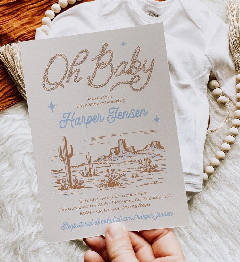 May include: A light brown baby shower invitation with a western theme. The invitation features a rope design that says "Oh Baby" in a cursive font. The text also includes the name "Harper Jensen" and details about the event, including the date, time, location, and RSVP information.