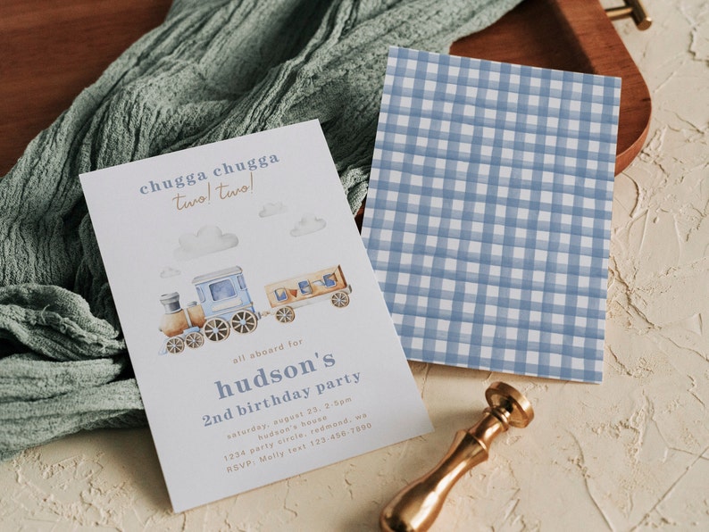 May include: A blue and brown train with white clouds and the text "chugga chugga two! two!"  All aboard for Hudson's 2nd birthday party. The invitation includes the date, time, location, and RSVP information.