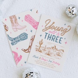 May include: A birthday invitation with a western theme. The invitation is decorated with a drawing of a desert landscape with cacti and mountains. The text reads "Young wild & THREE" and includes details for a birthday party.