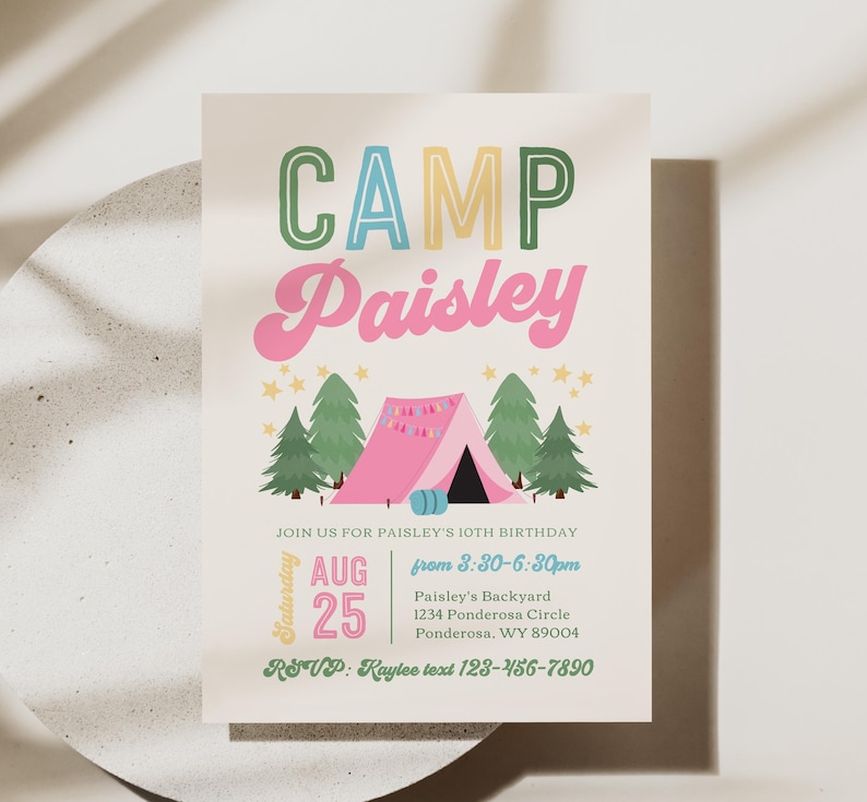 May include: A rectangular invitation card with a cream background featuring the text CAMP Paisley in green, blue, and pink. Below, a pink tent is surrounded by green pine trees and yellow stars. Details include date, time, and location for a 10th birthday.