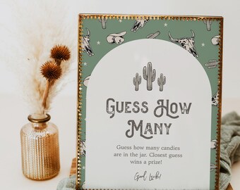 Può includere: Un cartello verde e dorato con un designo di cactus e teschio. Il cartello dice "Indovina quanti" e contiene istruzioni per un gioco di indovinello.