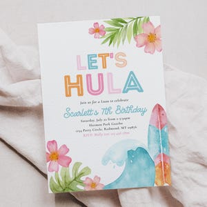 May include: A white invitation card with the text "LET'S HULA" in colorful letters, featuring watercolor illustrations of flowers, a surfboard, and a wave. The invitation is for Scarlett's 7th birthday luau.