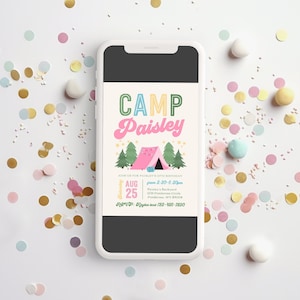 May include: A smartphone displays a colorful invitation for a camp-themed birthday party. The invitation features the text "CAMP Paisley" above a pink tent illustration, with details including the date, time, and RSVP information. Confetti in various colors surrounds the phone.
