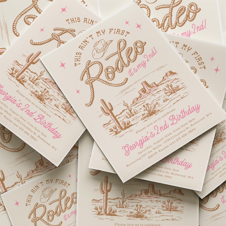 May include: A stack of rectangular birthday invitations on cream cardstock featuring brown line art of a desert landscape, a cowboy hat, and rope lettering that reads "THIS AIN'T MY FIRST Rodeo it's my 2nd!" with pink text "Georgia's 2nd Birthday".