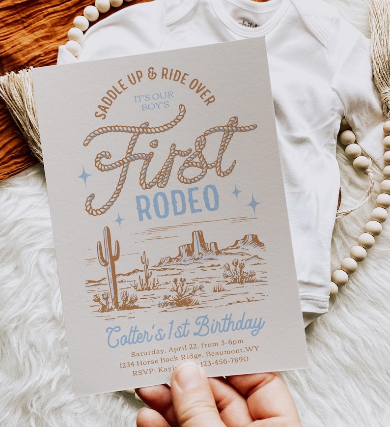 May include: A light blue and brown invitation with a rope design that says "Saddle Up & Ride Over It's Our Boy's First Rodeo". The invitation is for a first birthday party and includes the text "Cotter's 1st Birthday", the date, time, location, and RSVP information.