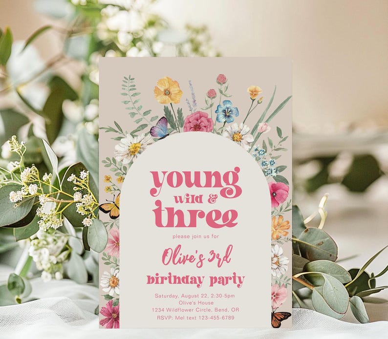 May include: A pink and white floral birthday party invitation with the text "young wild & three" and "Olive's 3rd birthday party". The invitation has a floral border and a white circle with the text in the center.