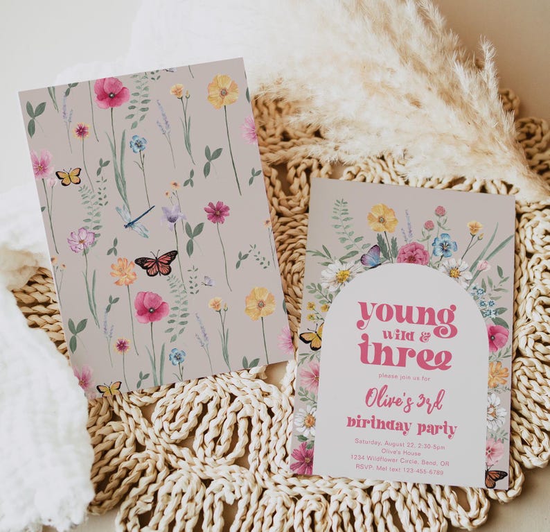 May include: A floral-themed birthday party invitation with a pink and white color scheme. The invitation features a whimsical illustration of flowers, butterflies, and a dragonfly. The text on the invitation reads "young wild & three" and "Olive's 3rd birthday party".