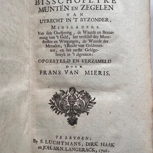 May include: A black and white image of a book cover with the title "Beschryving der Bisschoplyke Munten en Zegelen van Utrecht in 't Byzonder, Midsgaders" and the author "Frans van Mieris".