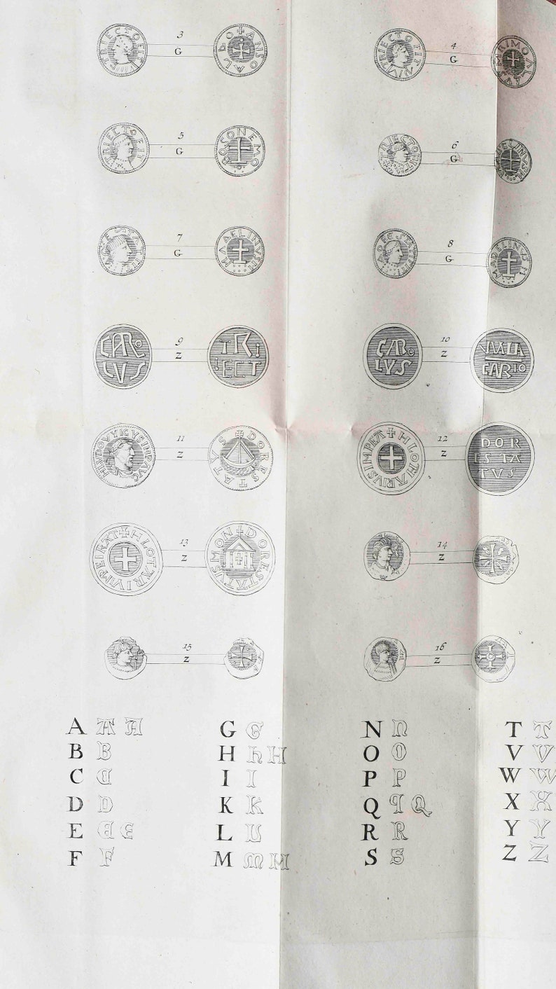 May include: A black and white image of a page from a book showing a chart of coins with different designs and letters. The chart is labeled with letters A through Z and numbers 1 through 16. The coins are arranged in two columns, with the letters on the left and the numbers on the right.
