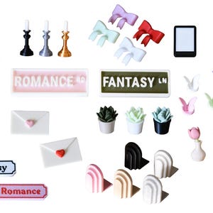 May include: A collection of miniature decorative items, including a white gargoyle, candlesticks, bows, an e-reader, boxes, butterflies, succulents, vases with flowers, skulls, and signs that read "Romance" and "Fantasy LN".