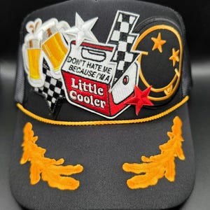 Don't Hate Me Because I'm a Little Cooler captains trucker hat, black