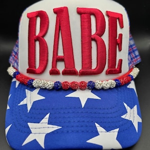 May include: A white ceramic mug with a black handle and the text "But First, Coffee" in a handwritten style. The mug is on a white surface. The mug is 4 inches tall.