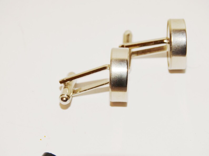 Love me Love me not cufflinks made from stainless steel.