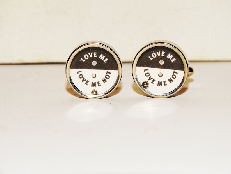 Love me Love me not cufflinks made from stainless steel.