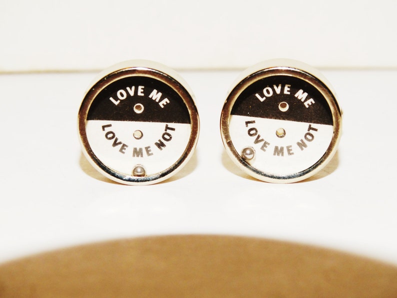 Love me Love me not cufflinks made from stainless steel.