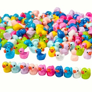 May include: A large pile of colorful miniature rubber duck figurines. The ducks are in various shades of blue, green, yellow, pink, and white. There is a row of ducks in the front of the image, with each duck in a different color.
