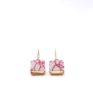 Square shaped dangle earrings in gold made out of ceramic porcelain