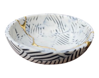 handmade 24k Gold Kintsugi bowl made of black and white porcelain