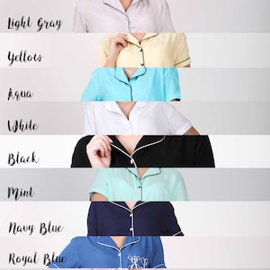 Puede incluir: Una colecci&oacute;n de 12 pijamas para mujer en varios colores, incluyendo coral, lavanda, gris claro, amarillo, aguamarina, blanco, negro, menta, azul marino, azul real, rosa claro y rosa intenso. Cada parte superior del pijama presenta un cuello abotonado y mangas cortas.