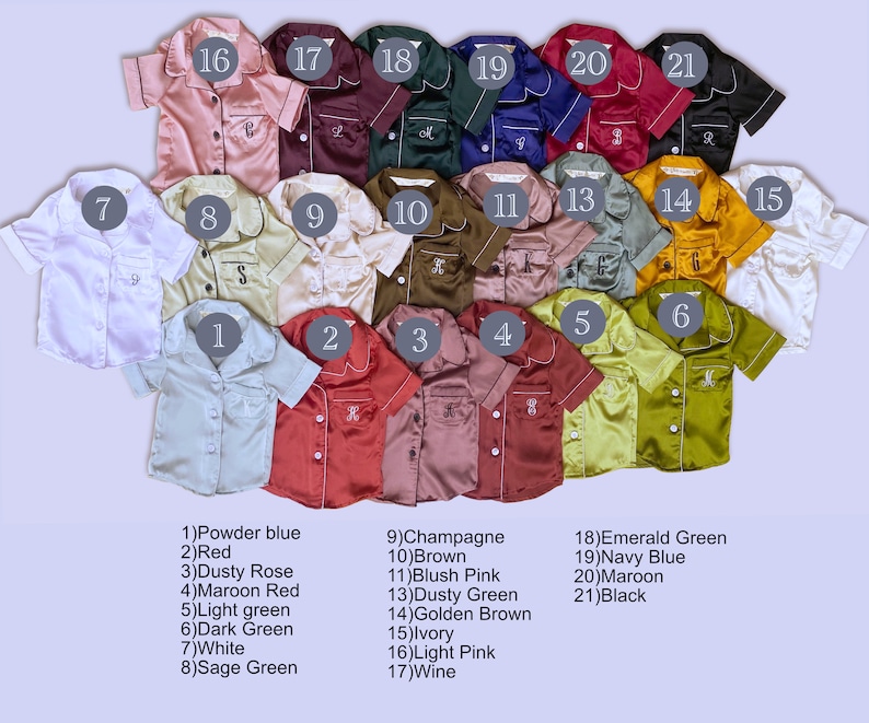 May include: Twenty-one satin pajamas for babies in various colors, including powder blue, red, dusty rose, maroon red, light green, dark green, white, sage green, champagne, brown, blush pink, dusty green, golden brown, ivory, light pink, wine, emerald green, navy blue, maroon, and black. Each pajama has a number from 1 to 21 printed on it.