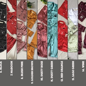 May include: A collection of 19 different color satin pajamas sets. Each set includes a short-sleeved shirt with a button-up closure and matching shorts. The pajamas are available in a variety of colors, including emerald green, light pink, champagne, powder blue, red, black, maroon, blush pink, golden brown, dusty rose, dusty green, red orange, sage green, wine, navy blue, ivory, white, dark green, and brown.