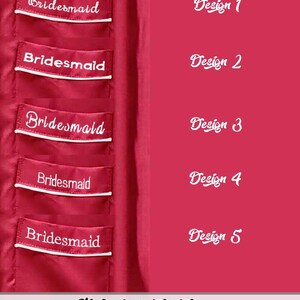May include: A deep pink fabric surface featuring five distinct embroidery font options for the word Bridesmaid, each displayed on a pocket flap with white piping. The text Design 1 through Design 5 labels each style, with Style 1 font options below.