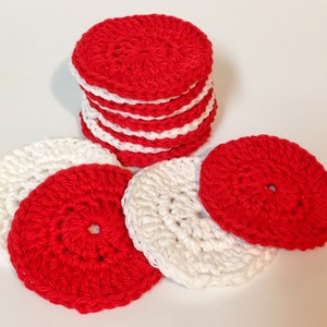 May include: A stack of red and white crocheted round pads. The pads are made of soft yarn and are perfect for cleaning makeup or removing nail polish.